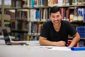 student-laughing-in-the-library